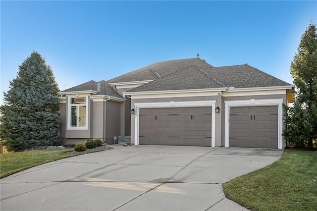 view of front of property featuring roof with shingles, a garage, driveway, and stucco siding