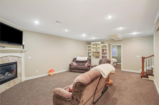 living area with stairway, baseboards, a premium fireplace, and carpet flooring