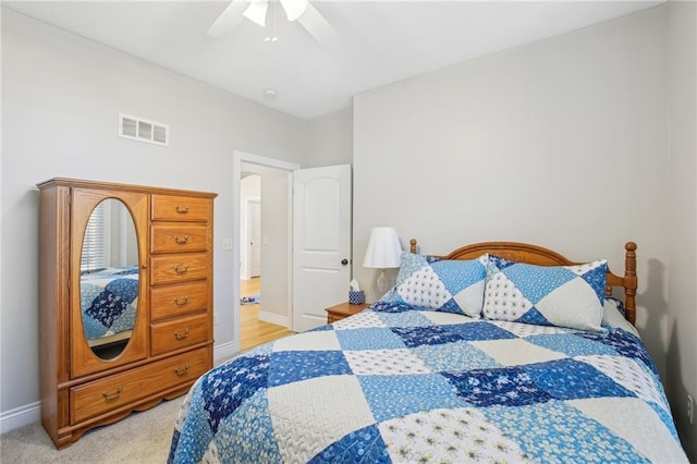 bedroom with light carpet, visible vents, a ceiling fan, and baseboards