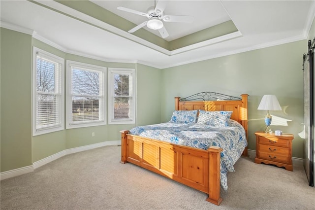 bedroom featuring a tray ceiling, light carpet, and baseboards