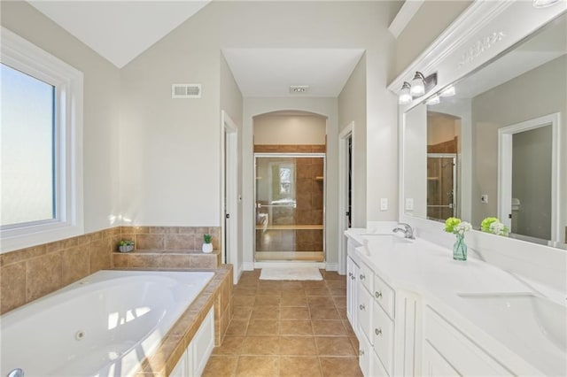 full bathroom with a tub with jets, visible vents, double vanity, a stall shower, and tile patterned flooring