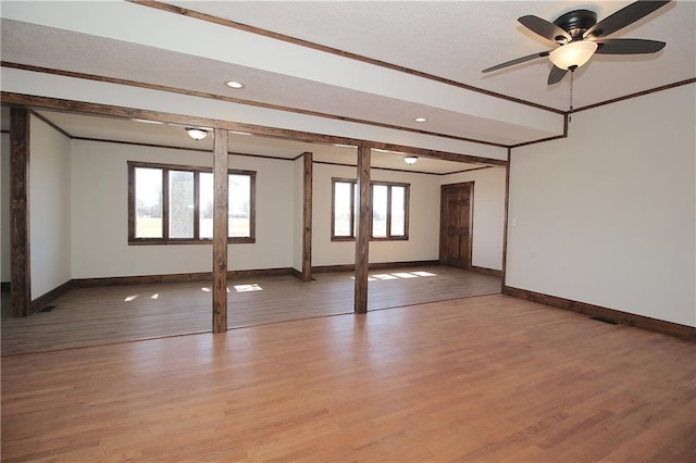 spare room featuring light wood-type flooring and crown molding