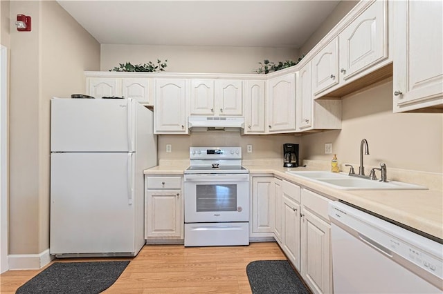 kitchen with under cabinet range hood, white appliances, light wood-type flooring, and a sink