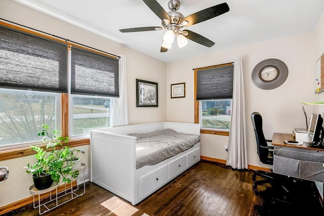 bedroom with baseboards, dark wood-style floors, and a ceiling fan