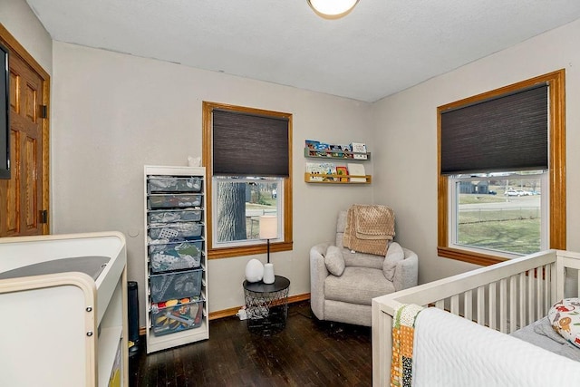 bedroom featuring baseboards and wood-type flooring