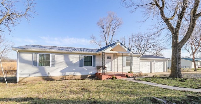 single story home featuring a front lawn, a garage, and metal roof