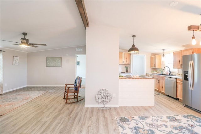 kitchen with light brown cabinets, open floor plan, lofted ceiling with beams, stainless steel appliances, and a sink