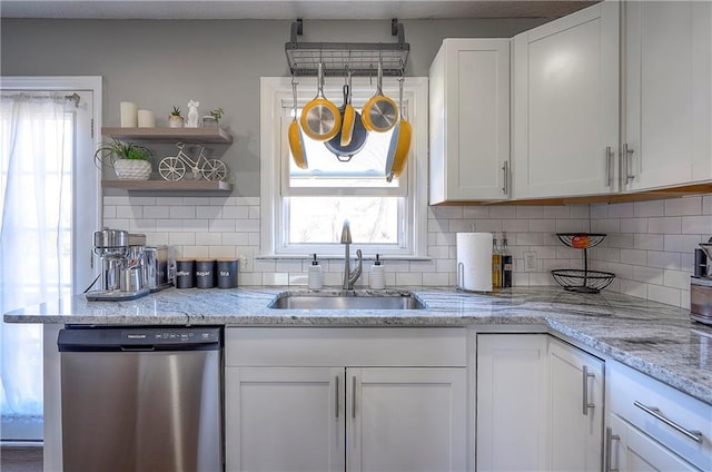 kitchen featuring dishwasher, open shelves, white cabinets, and a sink