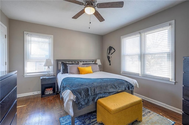 bedroom featuring ceiling fan, baseboards, and wood finished floors