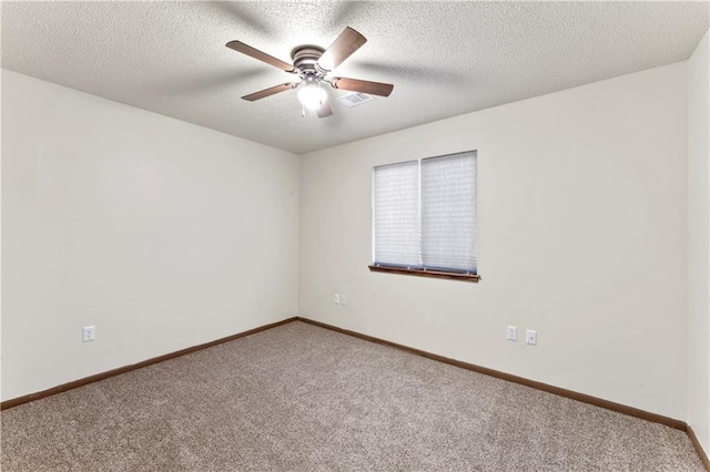 unfurnished room with a textured ceiling, carpet flooring, baseboards, and ceiling fan