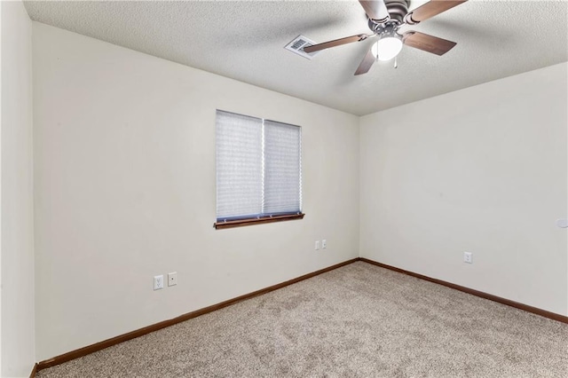 unfurnished room with baseboards, a ceiling fan, carpet flooring, and a textured ceiling