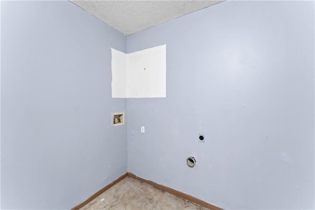 washroom featuring a textured ceiling, baseboards, hookup for an electric dryer, hookup for a washing machine, and laundry area