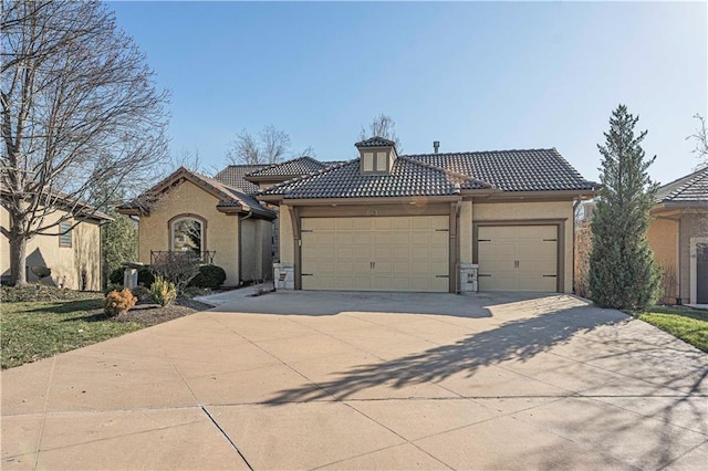 view of front of house with stucco siding, concrete driveway, an attached garage, and a tiled roof