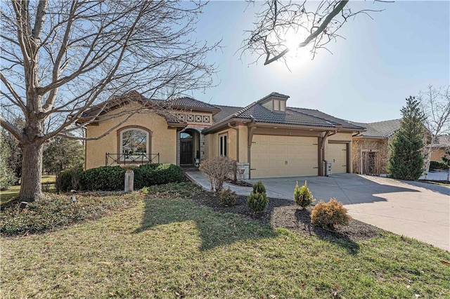 view of front facade with a front lawn, a tile roof, concrete driveway, stucco siding, and an attached garage