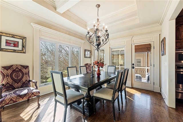 dining area with crown molding, baseboards, a chandelier, a tray ceiling, and dark wood-style floors