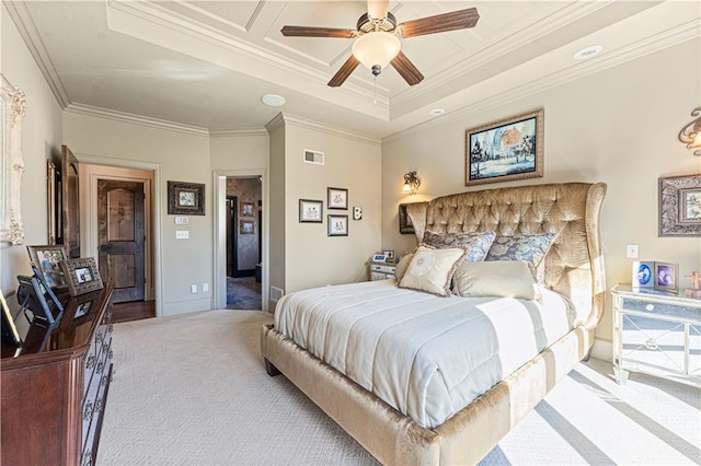 carpeted bedroom with a tray ceiling, visible vents, baseboards, and crown molding