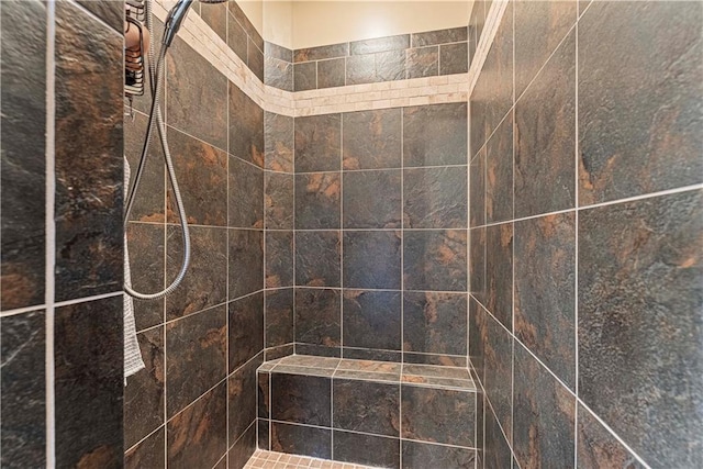 bathroom with tiled shower