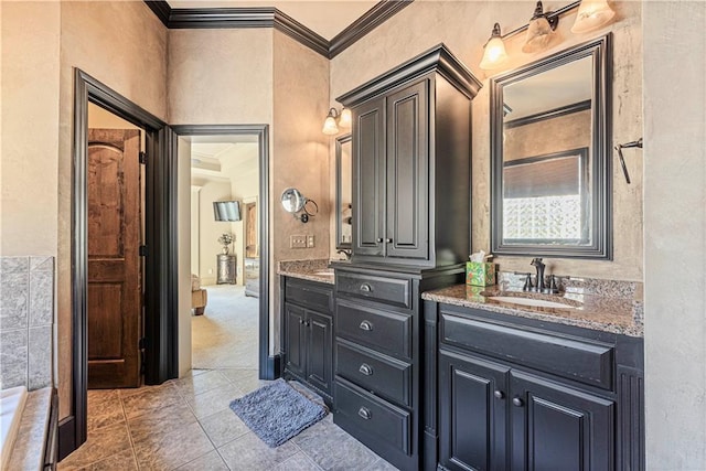 bathroom featuring a sink, double vanity, crown molding, and tile patterned floors