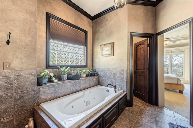 bathroom with a textured wall, a tub with jets, ensuite bathroom, and ornamental molding