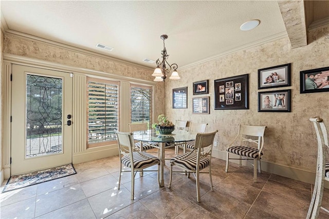 tiled dining room with visible vents, an inviting chandelier, crown molding, and baseboards