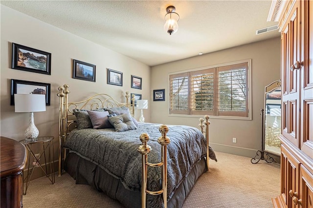 carpeted bedroom with visible vents, a textured ceiling, and baseboards