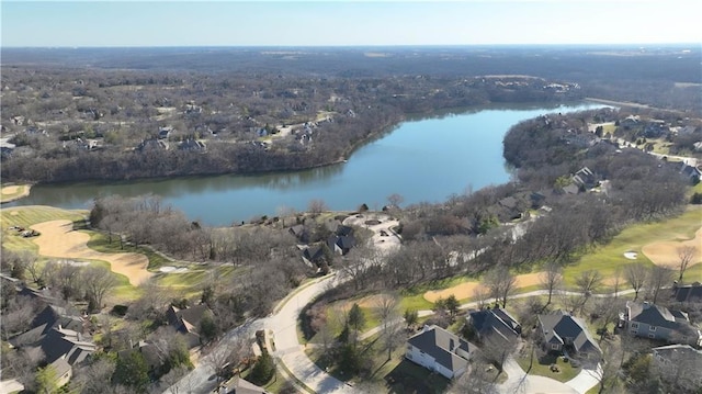 birds eye view of property with golf course view and a water view