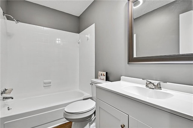 full bath featuring vanity, toilet, bathing tub / shower combination, and a textured ceiling