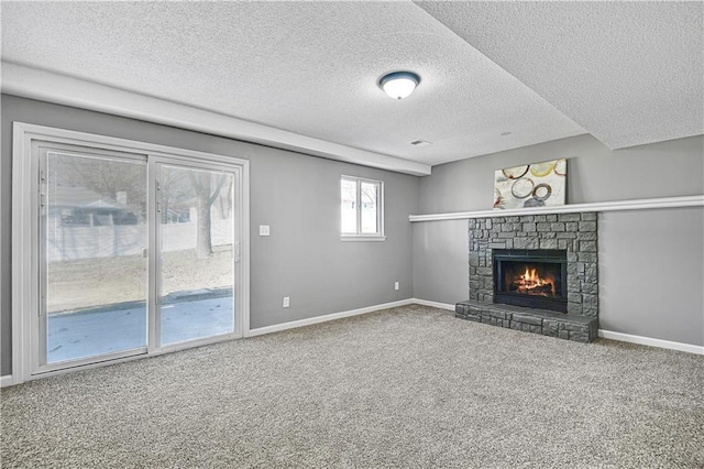 unfurnished living room featuring a fireplace, carpet, baseboards, and a textured ceiling