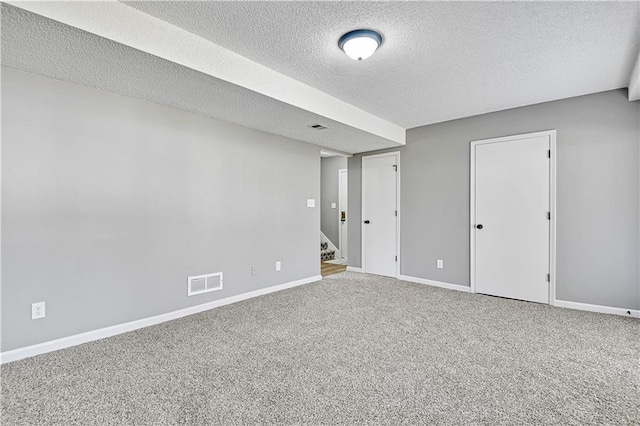 spare room featuring visible vents, stairway, baseboards, and carpet