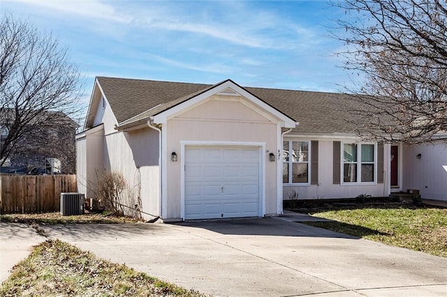 ranch-style house with central AC unit, fence, driveway, roof with shingles, and a garage