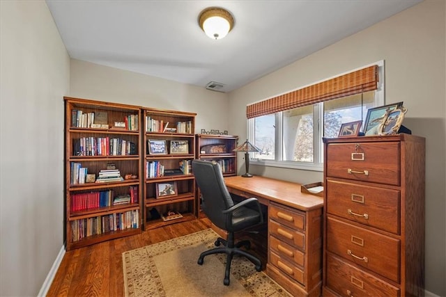 office featuring visible vents, baseboards, and wood finished floors