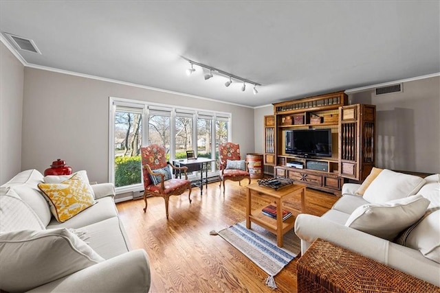 living room featuring visible vents, wood finished floors, ornamental molding, and track lighting