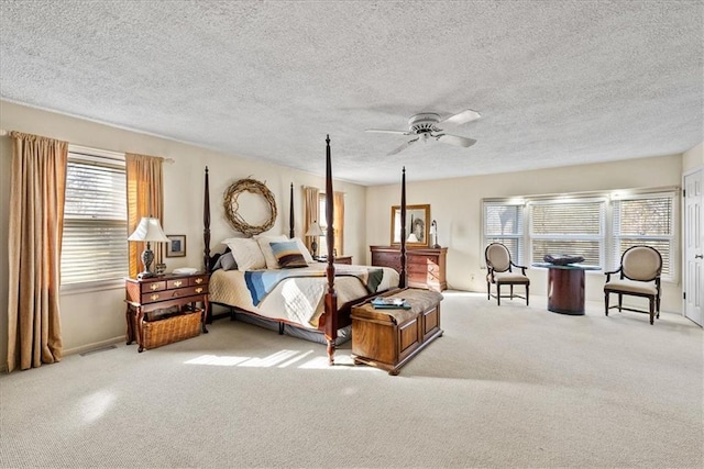 bedroom featuring a textured ceiling, carpet floors, and ceiling fan