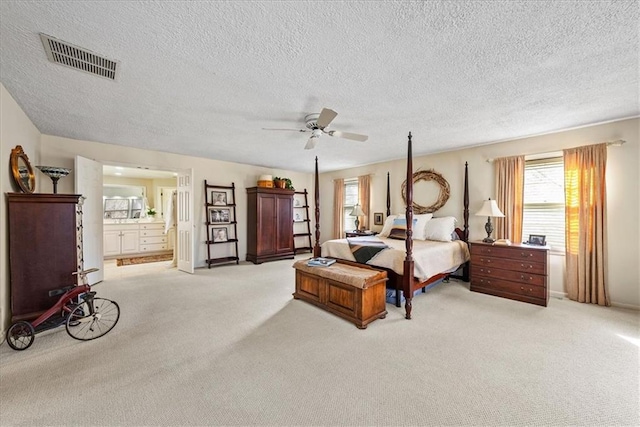 bedroom featuring visible vents, connected bathroom, ceiling fan, and carpet floors