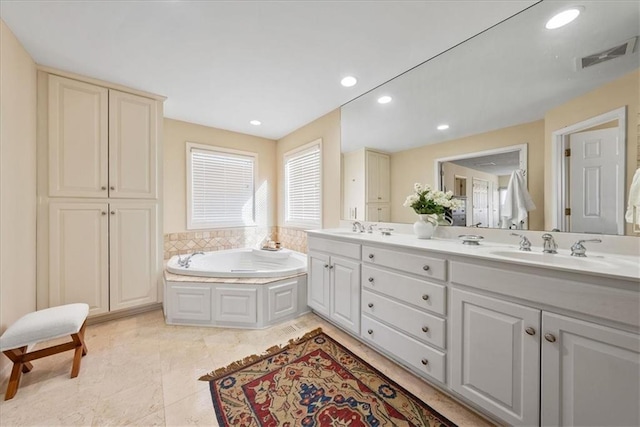 full bathroom with a sink, visible vents, a bath, and recessed lighting