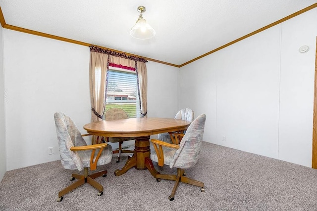 carpeted dining space featuring crown molding