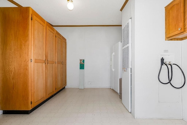 washroom with cabinet space, crown molding, light floors, and washer hookup