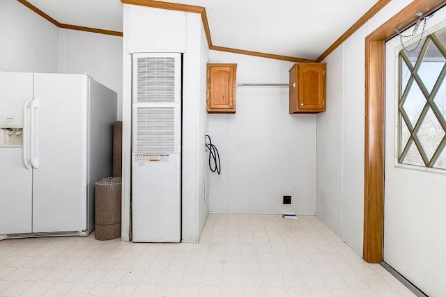 laundry area with a heating unit, a wealth of natural light, and ornamental molding