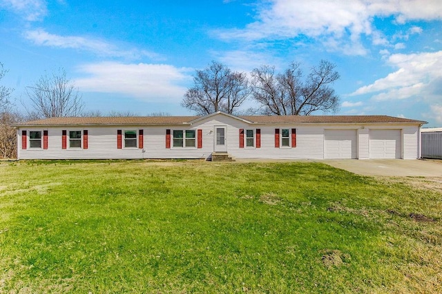 view of front facade with a garage, driveway, and a front lawn