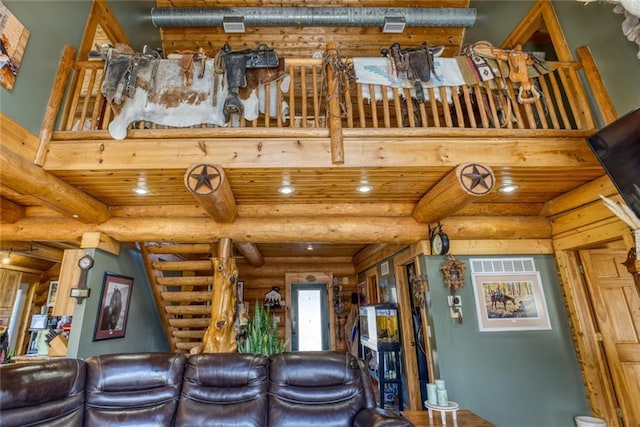 unfurnished living room with visible vents and beam ceiling