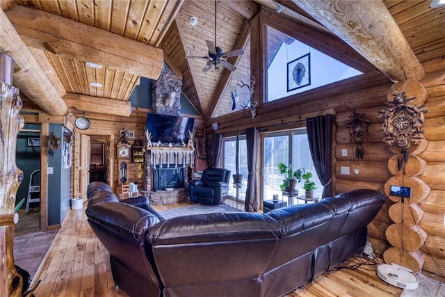 living room with hardwood / wood-style floors, high vaulted ceiling, beam ceiling, wooden ceiling, and a brick fireplace