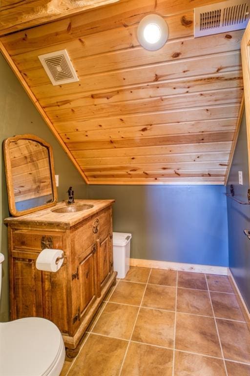 bathroom with tile patterned flooring, toilet, vanity, and visible vents