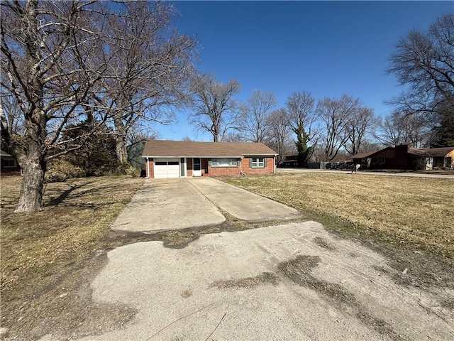 ranch-style home with a garage, brick siding, concrete driveway, and a front lawn