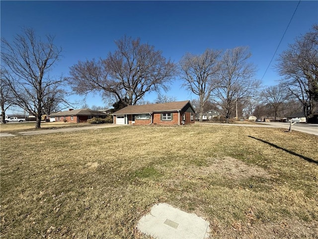 view of yard with concrete driveway and a garage