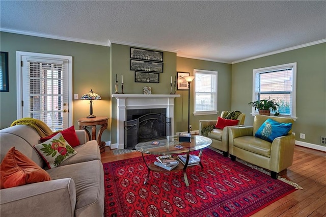 living room featuring hardwood / wood-style flooring, a fireplace, and ornamental molding