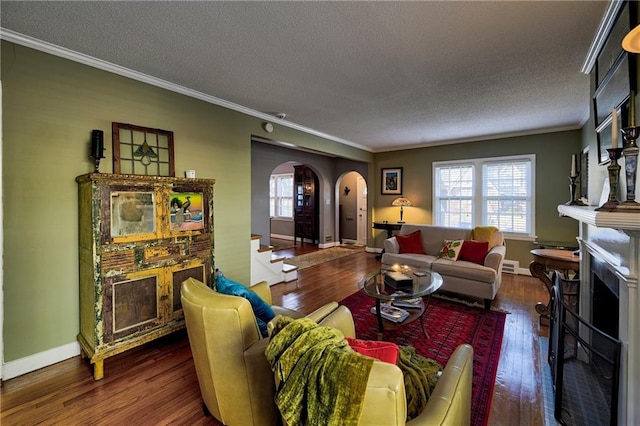 living room featuring arched walkways, a healthy amount of sunlight, wood finished floors, and a fireplace