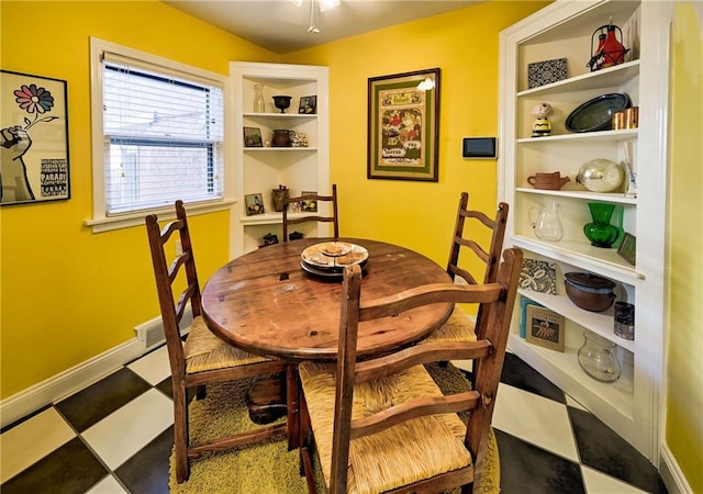 dining area with tile patterned floors, visible vents, baseboards, and built in features