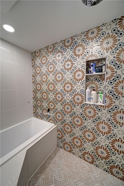 bathroom with tiled bath and tile walls