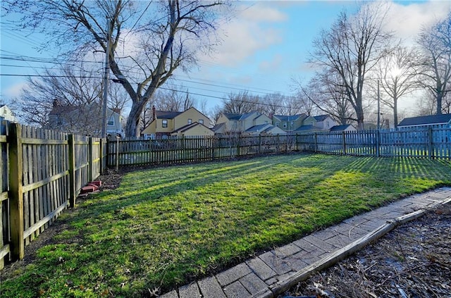 view of yard with a fenced backyard and a residential view