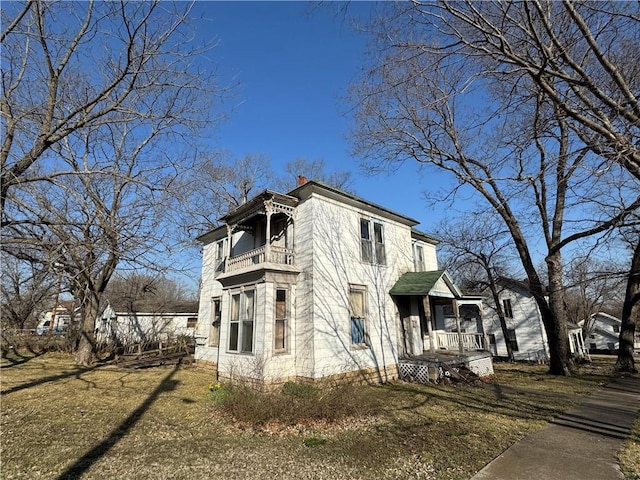 view of side of home with a balcony